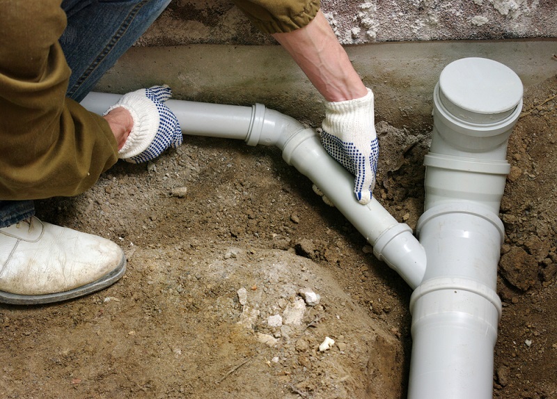 Drain Relining hands on pvc drain pipe