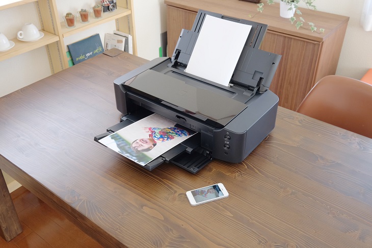 Ricoh Printer on desk with paper