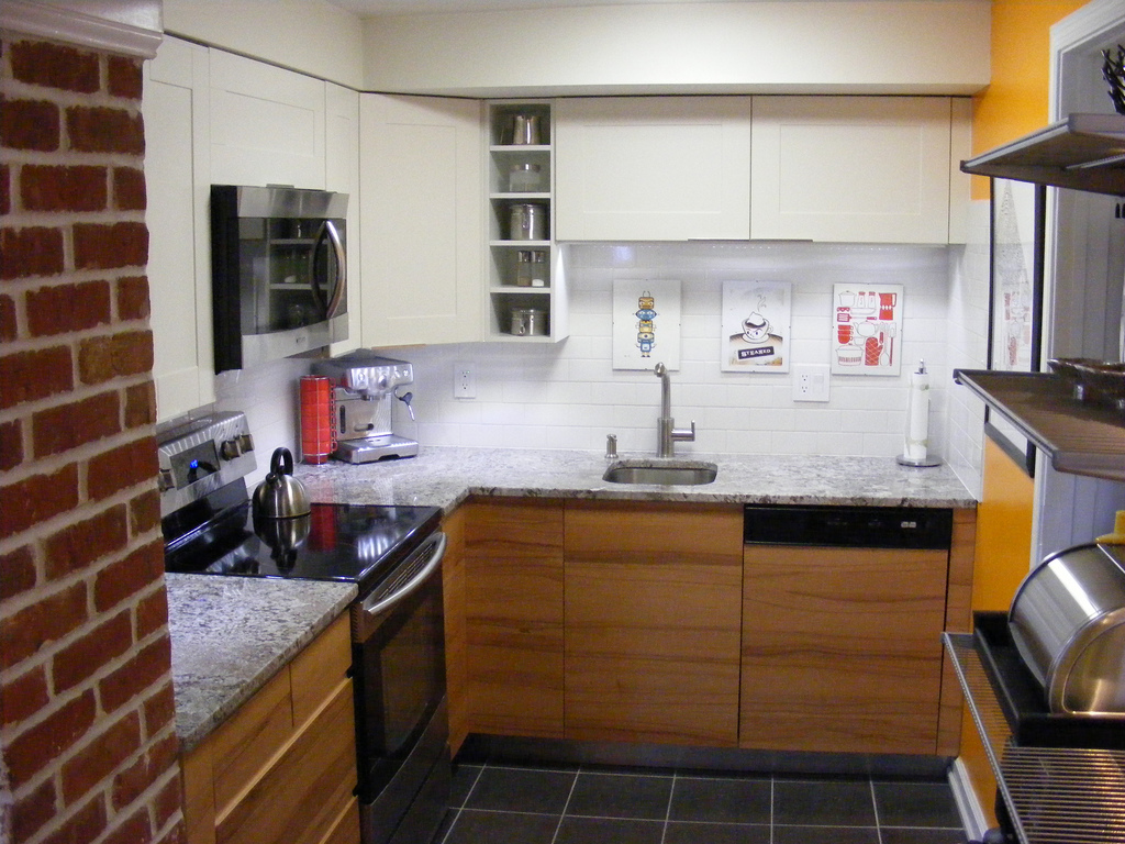 tiny kitchen with red brick walls