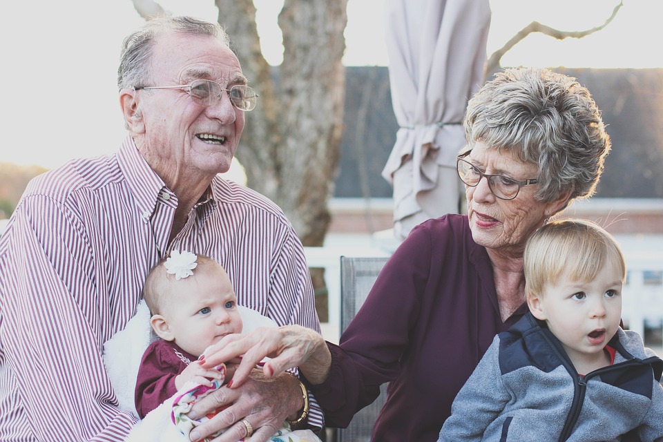 grandparents with grandchild smiling
