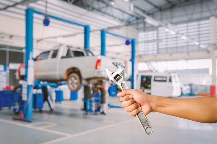 Car Servicing wrench in hand