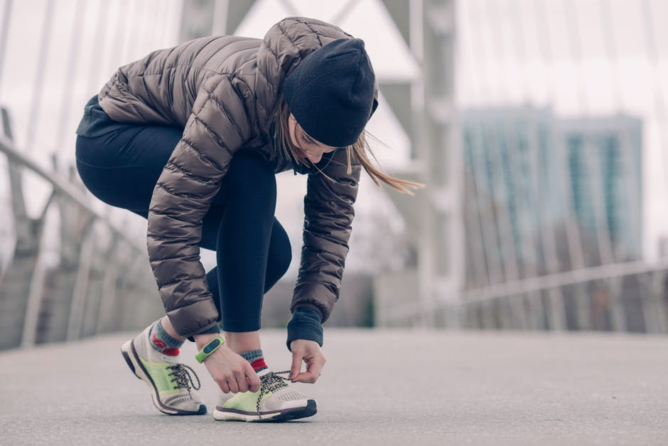Improve Your Body lacing up running shoes