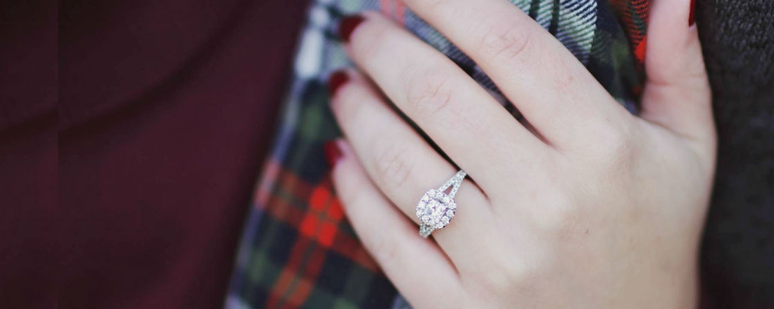 woman's hand wearing split shank engagement ring