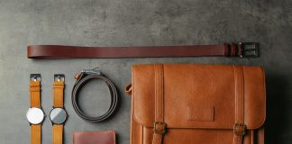 Flat lay composition with leather bag and accessories on grey st