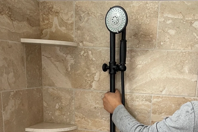 A-Rea-Pro-worker-demonstrates-an-adjustable-height-showerhead
